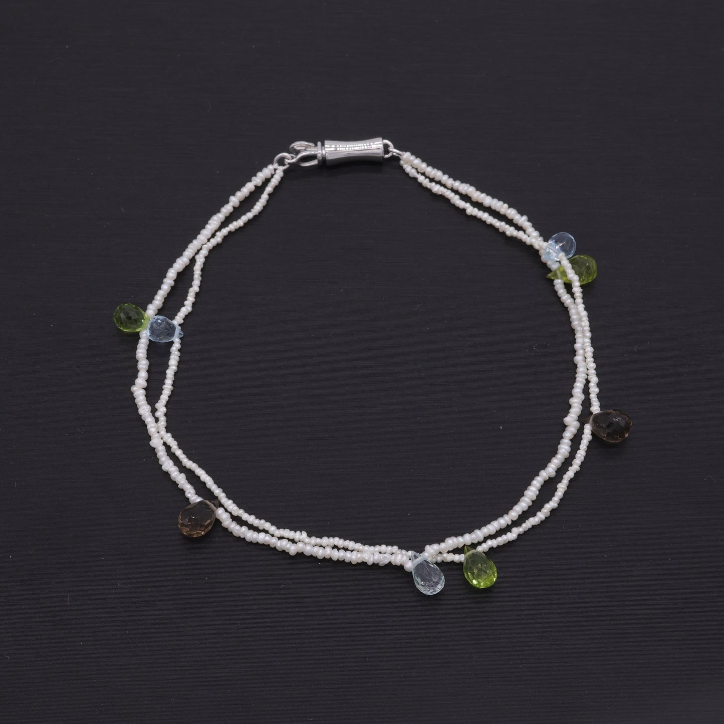 Hand-woven seed pearl bracelet with peridot, amethyst and aquamarine in sterling silver