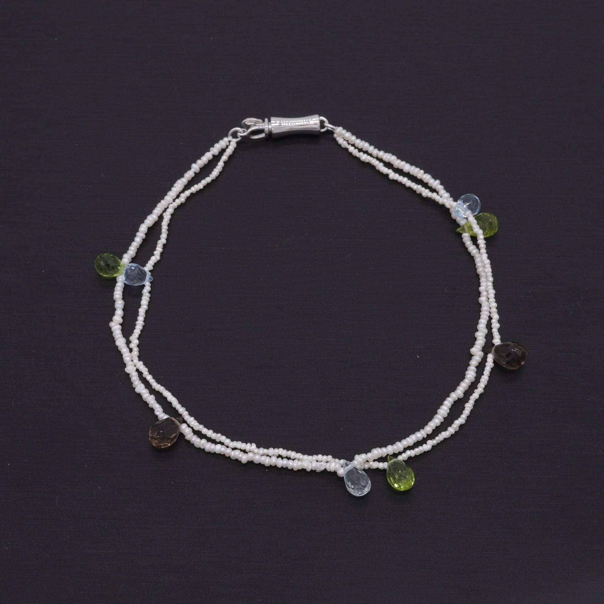 Hand-woven seed pearl bracelet with peridot, amethyst and aquamarine in sterling silver