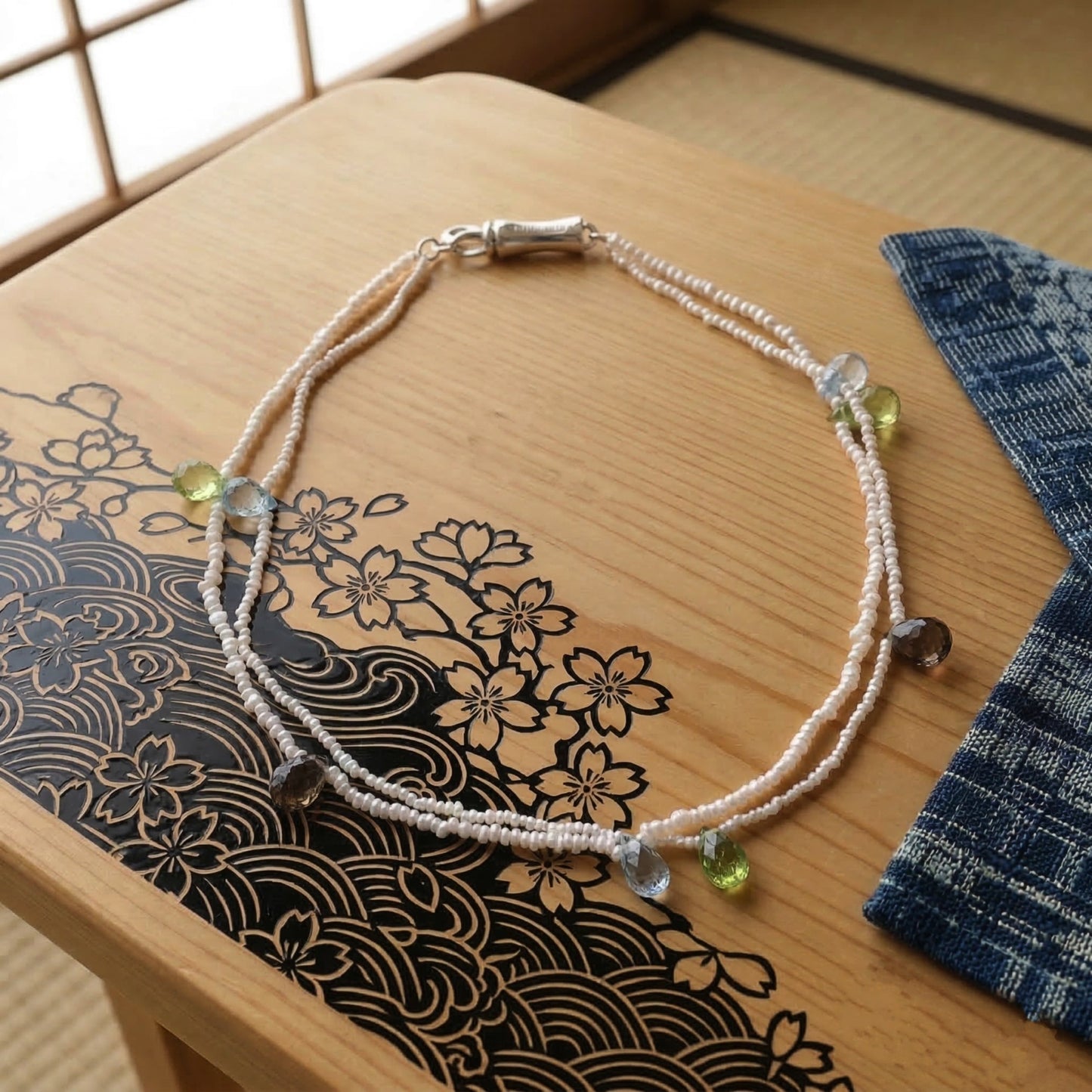 Hand-woven seed pearl bracelet with peridot, amethyst and aquamarine in sterling silver